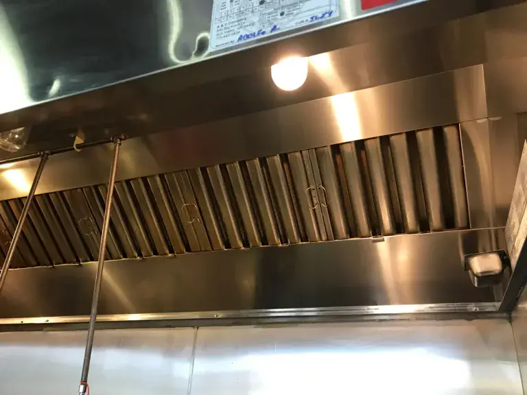 Commercial kitchen exhaust hood prepared for cleaning